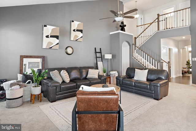 living room with carpet floors, high vaulted ceiling, and ceiling fan