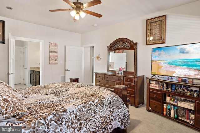 bedroom with connected bathroom, ceiling fan, and light colored carpet