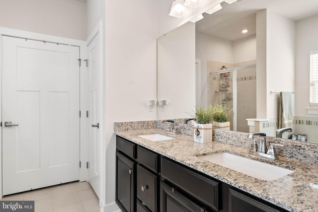 bathroom featuring tile patterned floors, vanity, and a shower with shower door