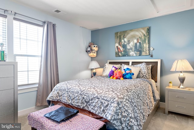 carpeted bedroom featuring multiple windows