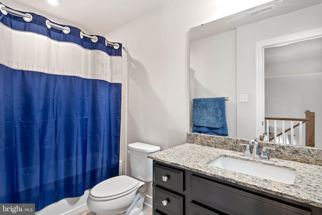 full bathroom featuring shower / bath combo with shower curtain, vanity, and toilet