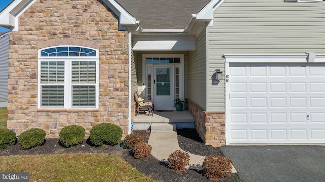 doorway to property with a garage