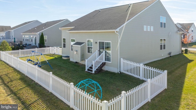 rear view of property with a lawn