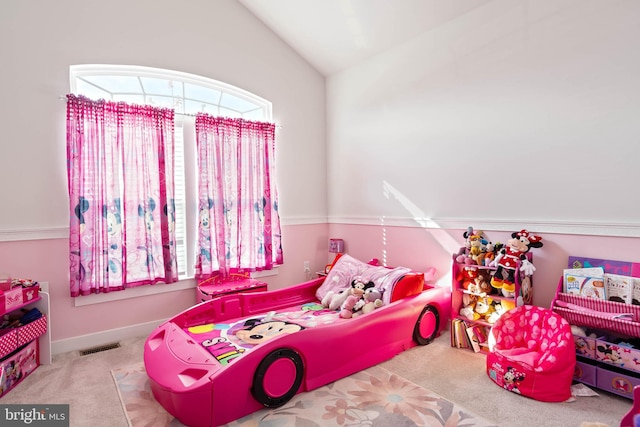 bedroom featuring light colored carpet and lofted ceiling