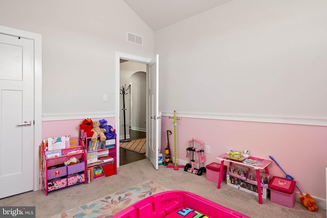 playroom featuring light carpet and vaulted ceiling