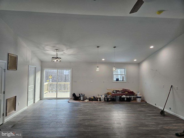 interior space with a wealth of natural light, dark wood-style flooring, and recessed lighting