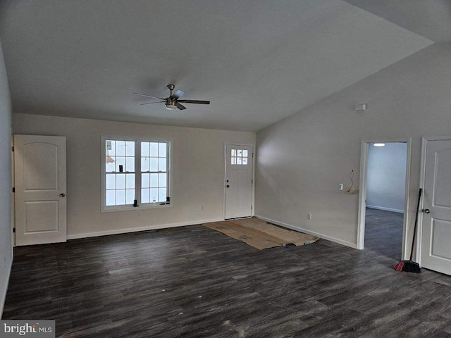 entrance foyer with lofted ceiling, ceiling fan, dark wood-type flooring, and baseboards