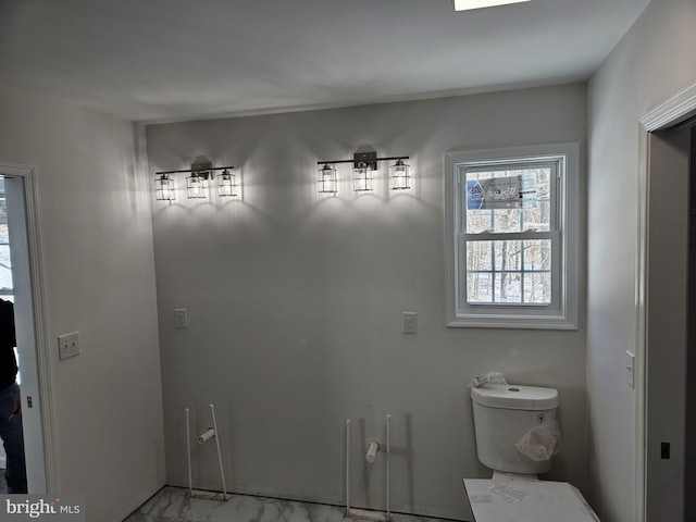 bathroom featuring marble finish floor and toilet