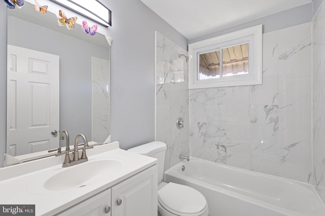 full bathroom with vanity, tiled shower / bath combo, and toilet