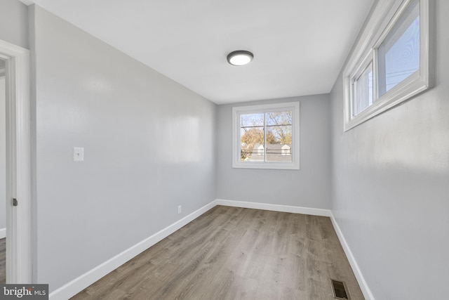 unfurnished room with light wood-type flooring