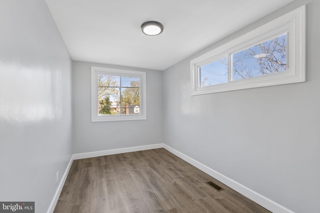 unfurnished room featuring hardwood / wood-style flooring