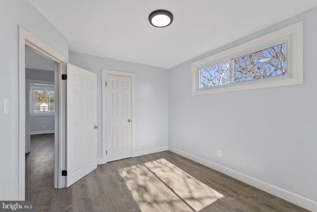 unfurnished bedroom with a closet and hardwood / wood-style flooring