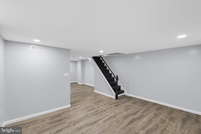 basement with light hardwood / wood-style floors