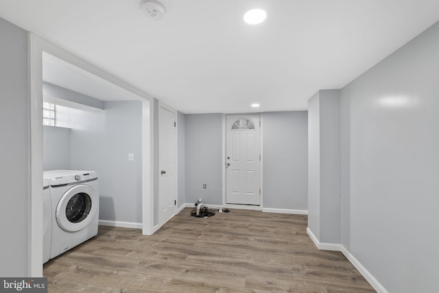 laundry room with washer / clothes dryer and light hardwood / wood-style floors