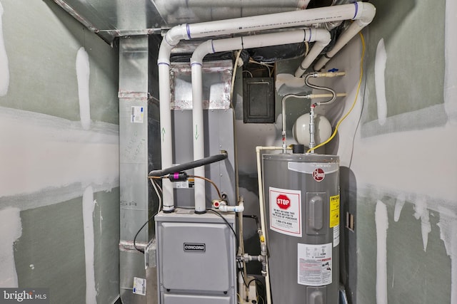 utility room featuring water heater