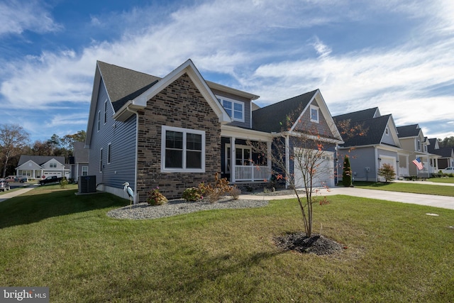 view of front facade with a front yard, a garage, and cooling unit