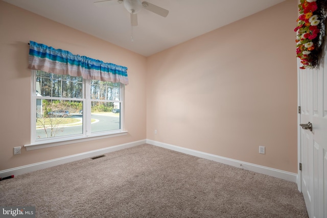 carpeted empty room featuring ceiling fan