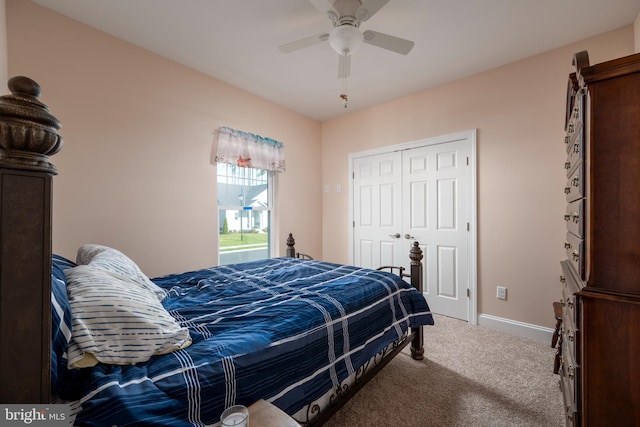 carpeted bedroom with ceiling fan and a closet