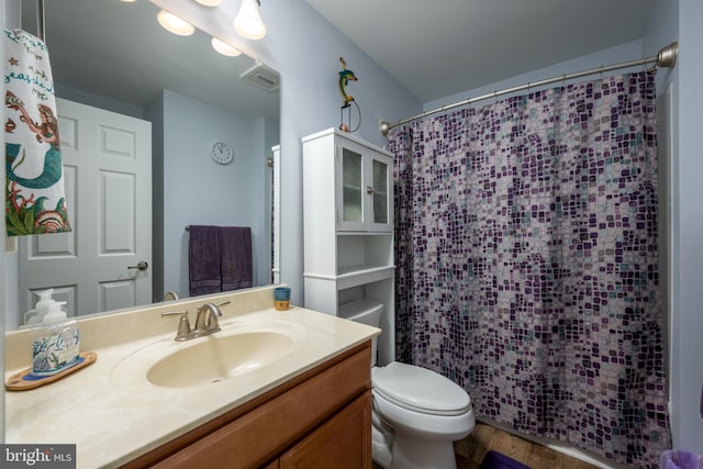 bathroom with curtained shower, toilet, vanity, and hardwood / wood-style flooring