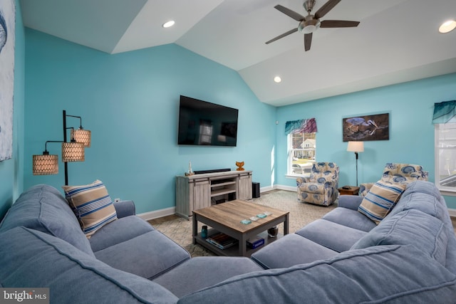 carpeted living room with ceiling fan and lofted ceiling