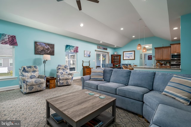 living room featuring ceiling fan, light colored carpet, and vaulted ceiling