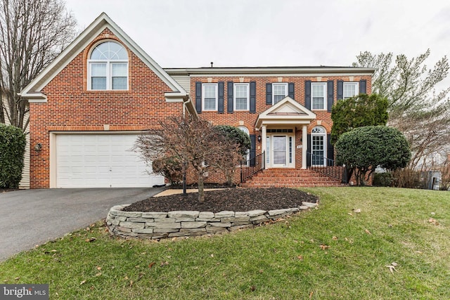 view of front of home featuring a front yard and a garage