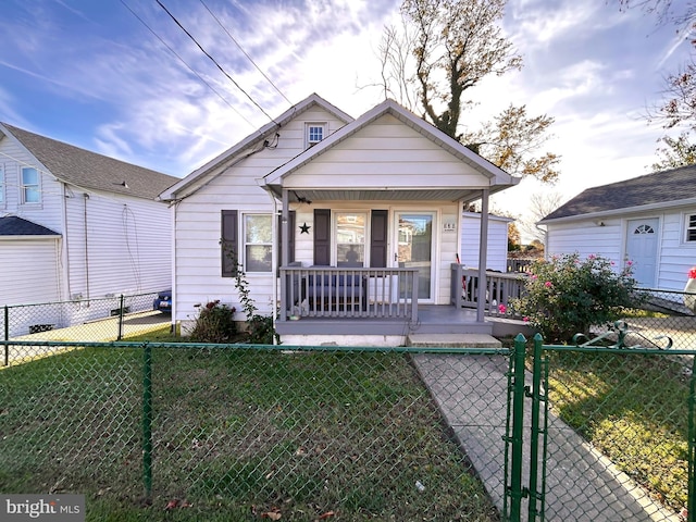 bungalow-style house with a porch and a front lawn