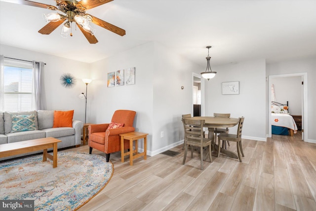 living room featuring ceiling fan and light wood-type flooring