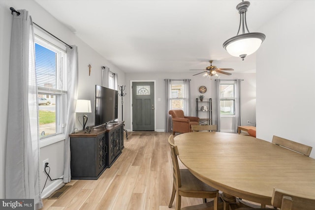 dining area with light hardwood / wood-style flooring, ceiling fan, and a healthy amount of sunlight