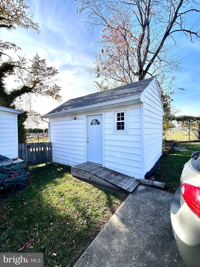 view of outbuilding with a lawn