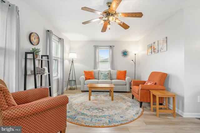 living room with ceiling fan and light wood-type flooring