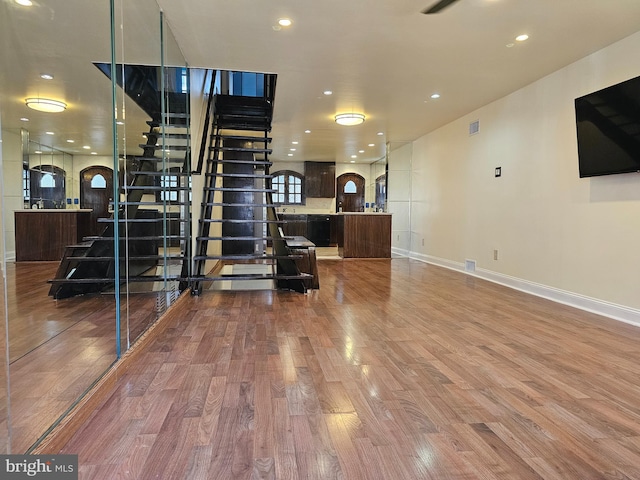 interior space with dark brown cabinets and hardwood / wood-style flooring