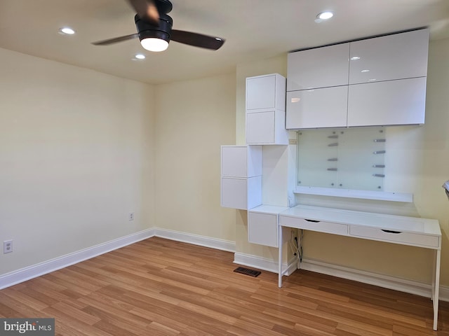 kitchen with white cabinetry, light hardwood / wood-style flooring, and ceiling fan