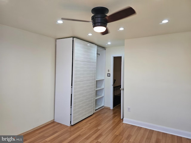 unfurnished bedroom with a closet, ceiling fan, and light hardwood / wood-style flooring