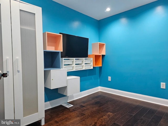 unfurnished office featuring dark hardwood / wood-style flooring