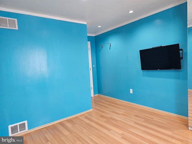 unfurnished room featuring wood-type flooring and ornamental molding