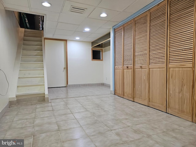 basement featuring a paneled ceiling