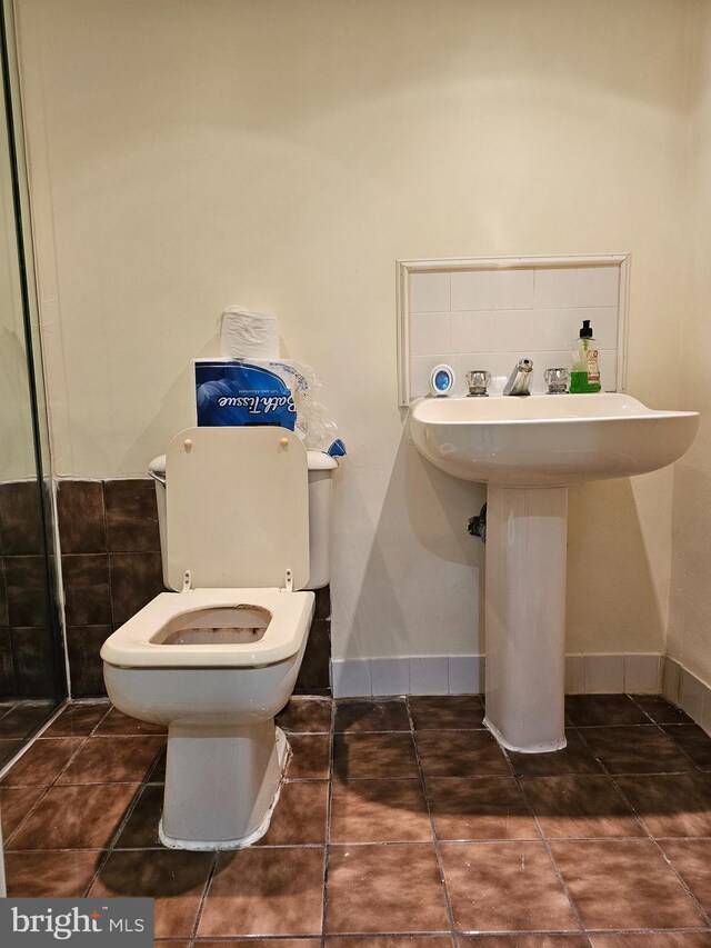 bathroom with tile patterned flooring, toilet, and sink