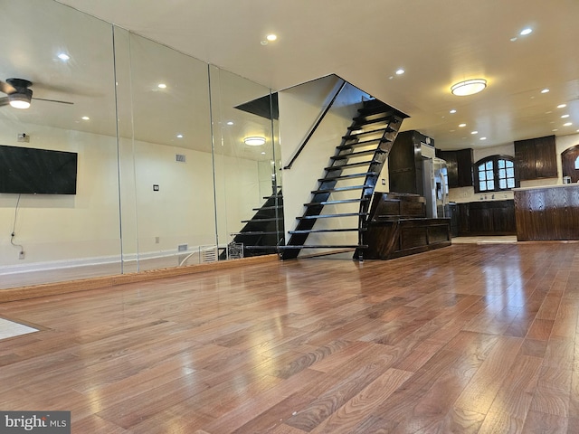 unfurnished living room with light hardwood / wood-style floors and ceiling fan