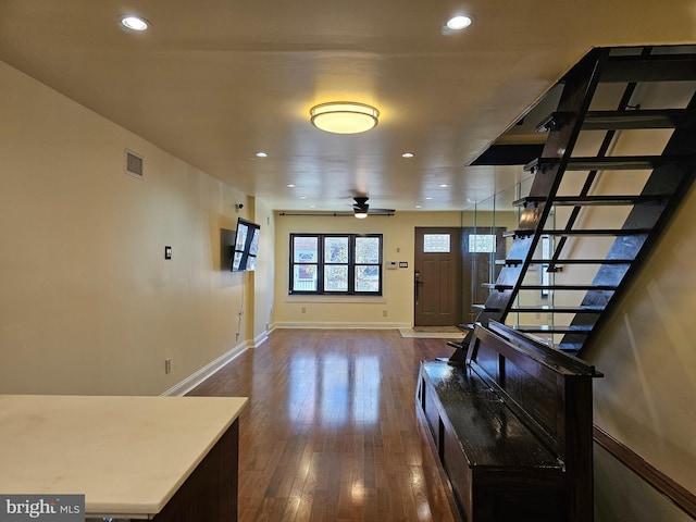 interior space with ceiling fan and dark wood-type flooring