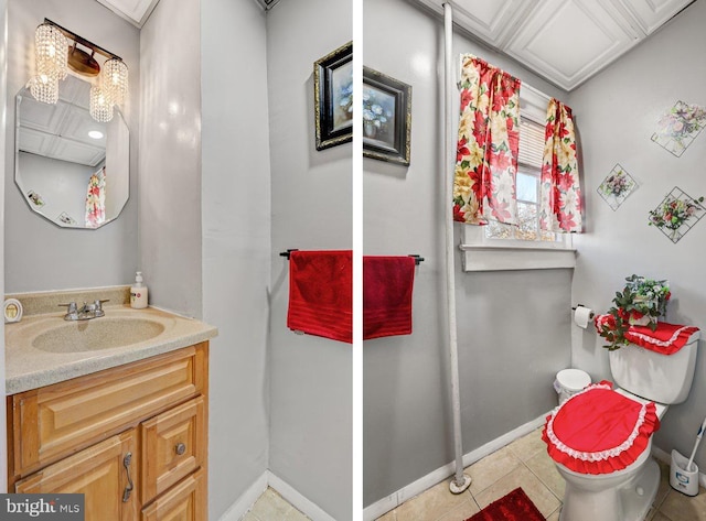 bathroom with tile patterned flooring, vanity, and toilet