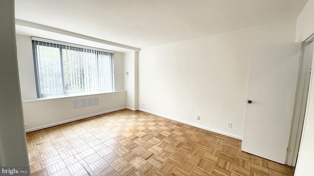 spare room featuring light parquet floors