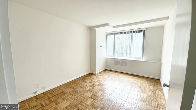 unfurnished room featuring light parquet flooring