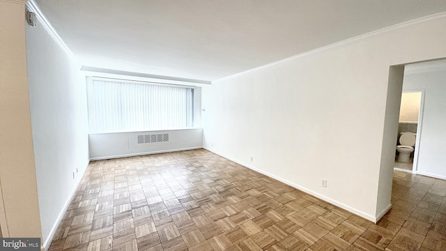 empty room featuring light parquet flooring and ornamental molding