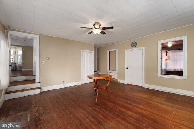 spare room with dark hardwood / wood-style floors and ceiling fan