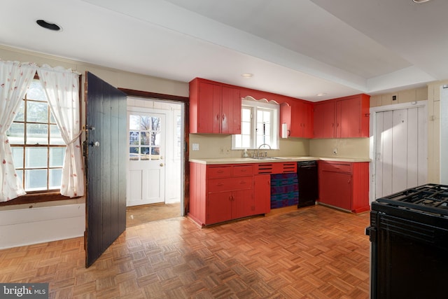 kitchen featuring sink, parquet floors, and black appliances