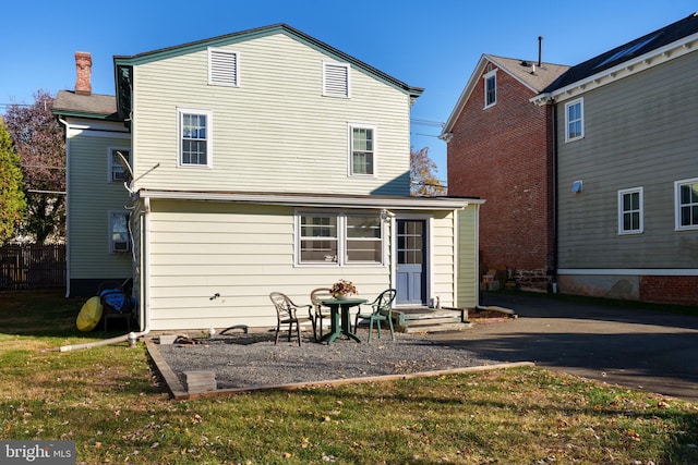 back of property featuring a lawn