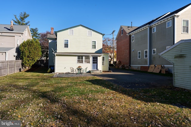 rear view of house featuring a yard and a patio area