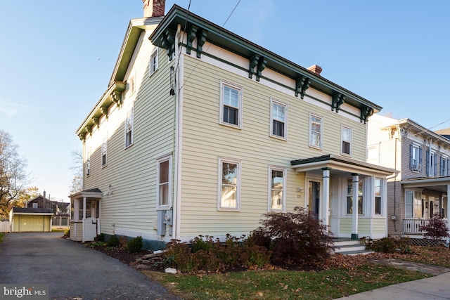 120 S Main St, Pennington, NJ 08534 - view of front of property with a chimney, covered porch, and a detached garage