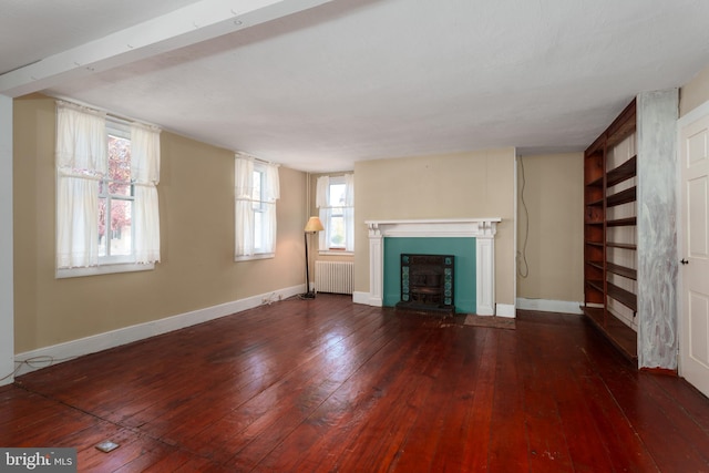 unfurnished living room with radiator heating unit and dark wood-type flooring